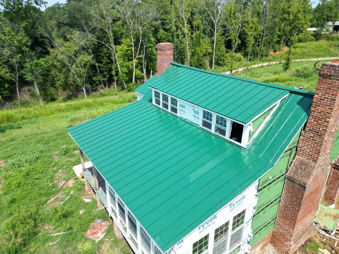 Green standing-seam metal roof installed by Lounsbury Roofing